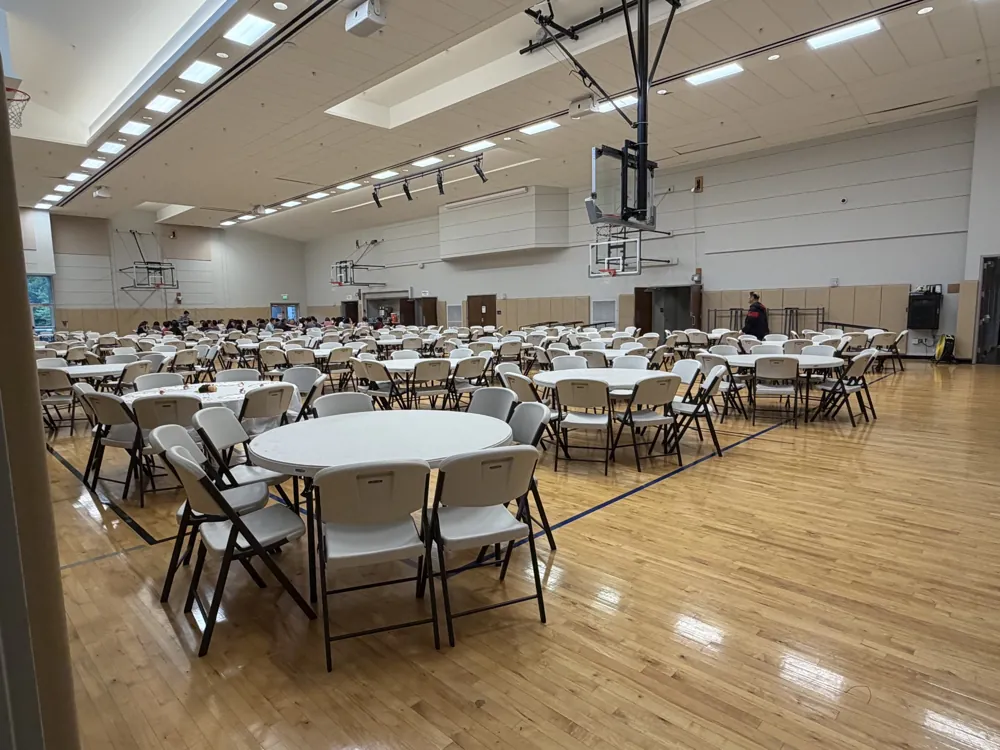 Church fellowship hall set with round tables for the senior day event at Bethel Korean Presbyterian Church