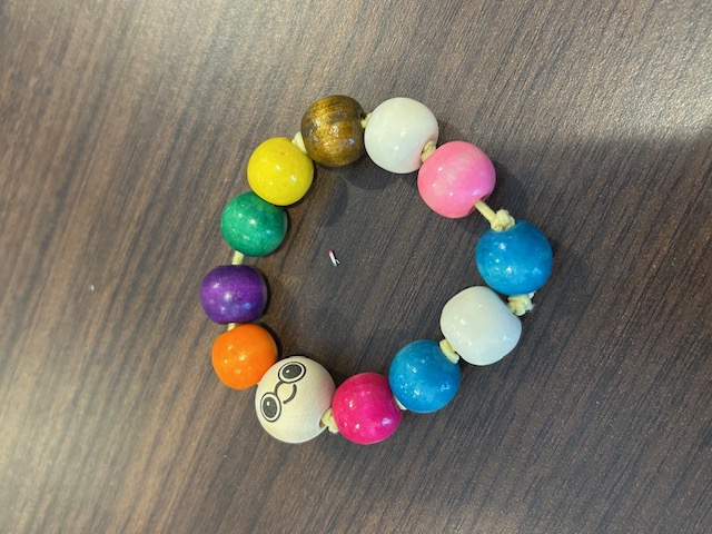 Beaded bracelet with a smiley-face wood bead