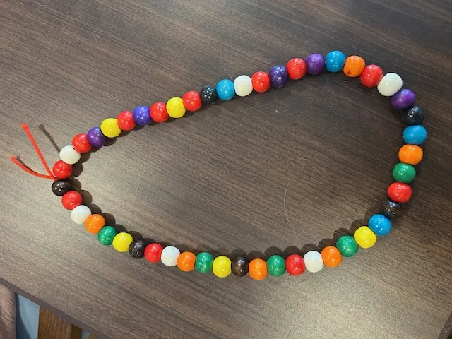 Long beaded necklace in red, yellow, green, and blue