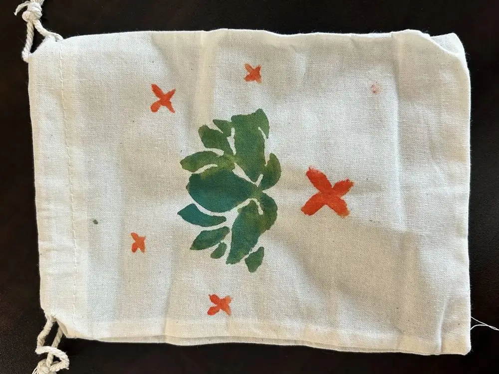 Hand-painted drawstring bag with a leaf design