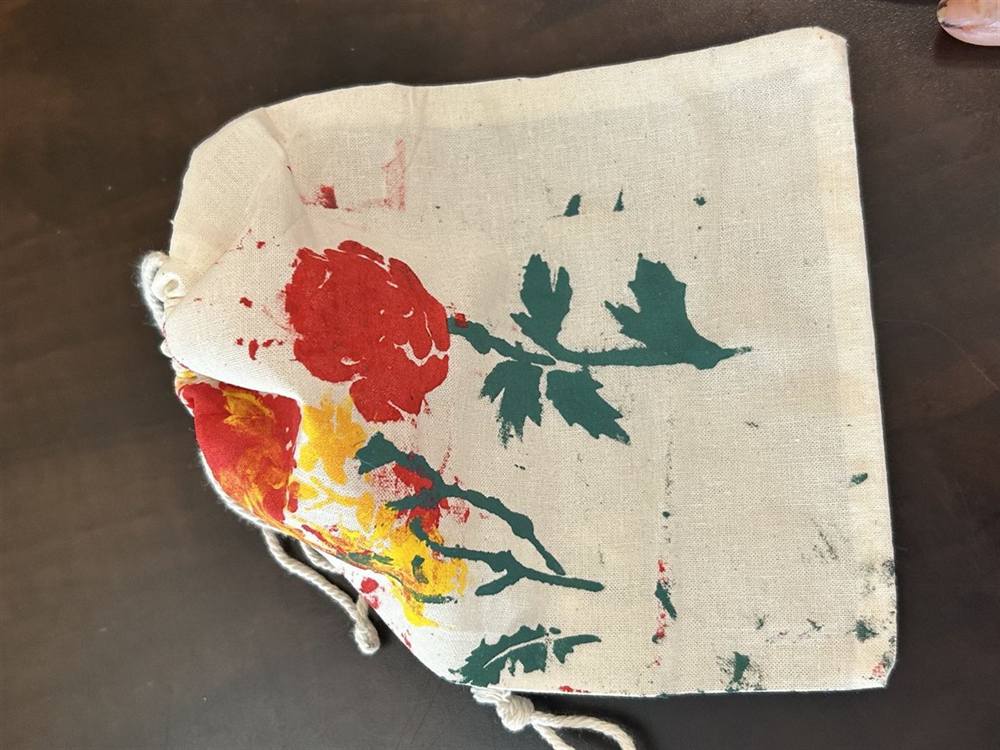 Hand-painted drawstring bag with a rose design
