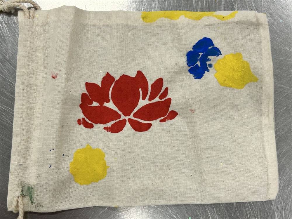Hand-painted drawstring bag with a lotus flower design