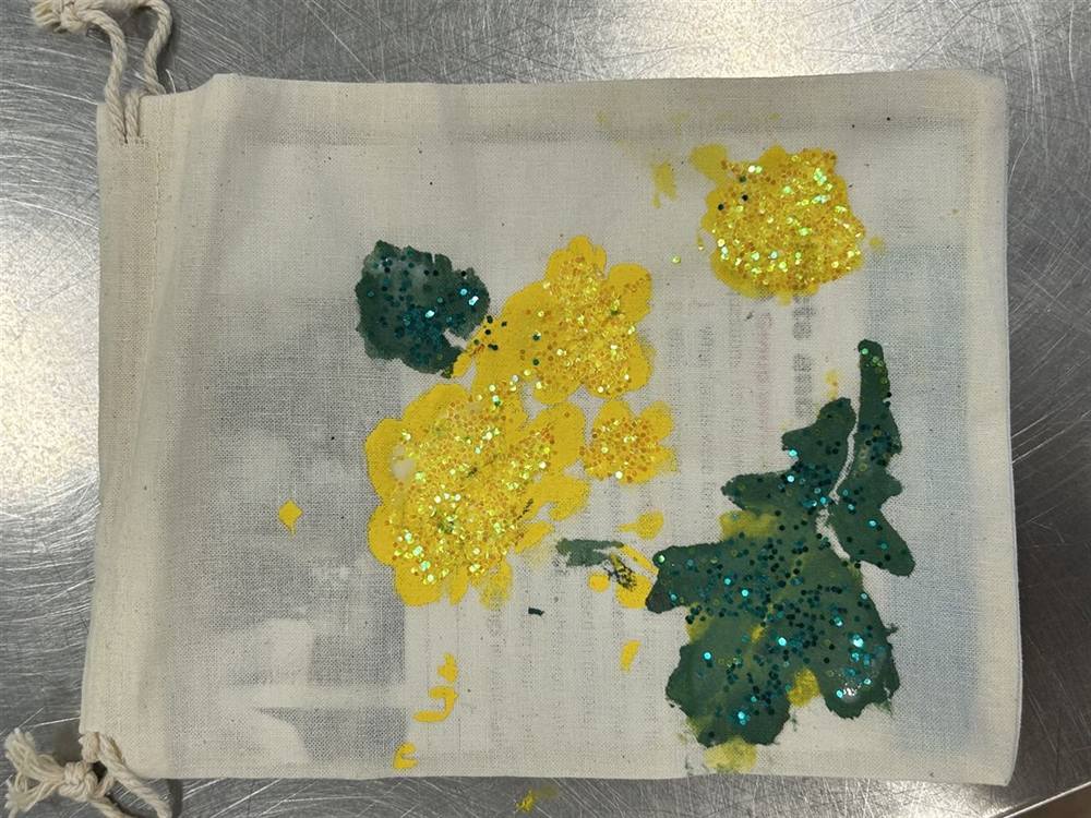 Hand-painted drawstring bag with glitter flowers